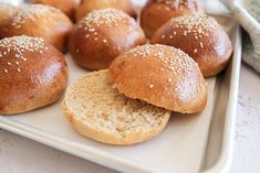 several rolls on a plate with sesame seeds