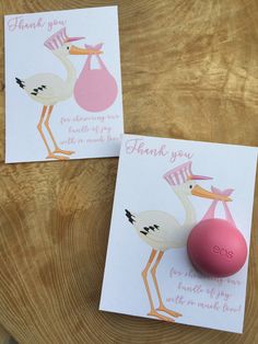 two cards with storks holding a baby's bottle and thank you note