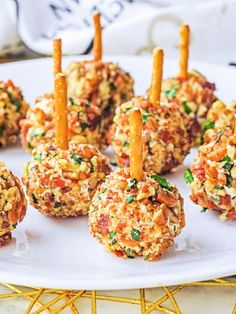 small appetizers are arranged on a plate with toothpicks sticking out of them