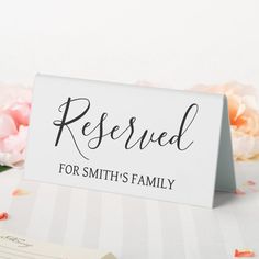 a sign that says reserved for smith's family next to flowers and a note