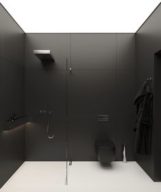 a black and white bathroom with an open shower