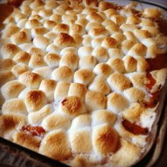 an uncooked pizza sitting on top of a baking pan covered in cheese and sauce