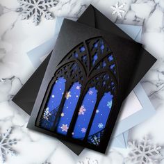 a card with snowflakes on it and an image of a window in the background