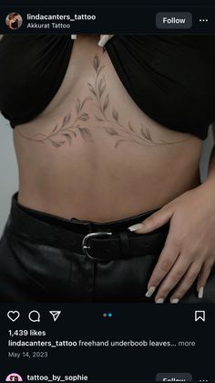 a woman's stomach with tattoos on it, and the bottom part of her belly