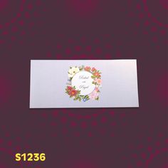 a white card with flowers on it