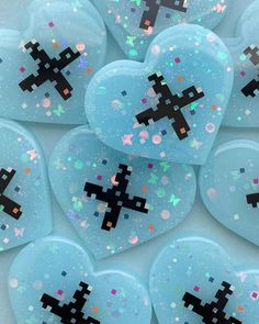 some blue heart shaped objects with black crosses on them