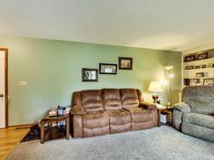 a living room filled with furniture and a lamp