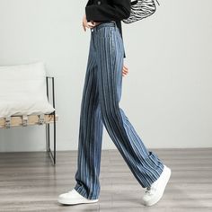 Unleash Your Style with Every Step Discover the perfect blend of retro charm and modern fashion with our High-Waist Striped Wide-Leg Jeans. Designed for women who appreciate both style and comfort, these jeans feature a striking striped pattern that sets you apart from the crowd. Whether you're stepping out for a casual coffee date or gearing up for a day in the city, these pants promise versatility and a trendy look for every season. Product Features Our wide-leg jeans are crafted from a high-quality mix of cotton and viscose, ensuring breathability and comfort. The slight stretch in the fabric accommodates your every move, making them ideal for all-day wear. With a loose fit and a high-rise design, they accentuate your waist and elongate your legs, providing a flattering silhouette for a Trendy Denim Wide Leg Trousers, Mid-rise Blue Wide Leg Pants For Fall, Chic Blue Wide Leg Jeans, Chic Non-stretch Denim Bottoms, Chic Blue High-waisted Flare Jeans, Trendy Straight Denim Blue Pants, Chic High Waist Denim Blue Bottoms, Retro Wide Leg Denim Blue Bottoms, Chic High-waist Denim Blue Bottoms