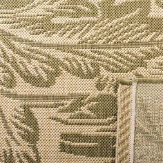 a close up view of the back side of a rug with an embroidered design on it