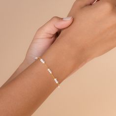 P E A R L ∙ B R A C E L E T Our elegant and delicate Pearl Charm Bracelet is the ultimate accent to your bridal look. Give this minimalist charm bracelet as a gift to your bridesmaids or gift to yourself on the big day. * Material: High Quality Solid 925 Sterling Silver  * Finish: Sterling Silver ∙ 18K Gold  * Featuring ~3-5mm Pearl Charms on a minimalist chain, adjustable 6 to 8 inches. O T H E R ∙ I N F O R M A T I O N * All items are nicely packaged ready to gift in elegant jewelry boxes. Our Pave Heart Necklace, Minimalist Chain, Pearl Charm Bracelet, Station Bracelet, Fingerprint Jewelry, Heart Locket Necklace, Baroque Pearl Earrings, Bridesmaid Bracelet, Bridal Look