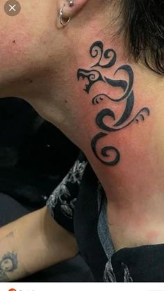 a woman with a tattoo on her neck