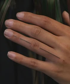 a person's hand with a ring on top of it and a line across the middle of their finger