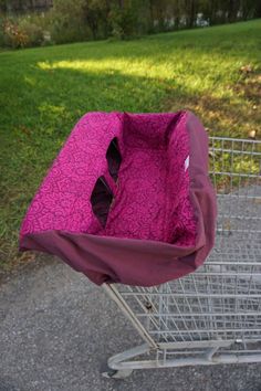 a shopping cart with a pink bag in it