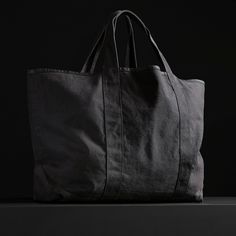 The perfect travel tote bag with an inside pocket and comfortable shoulder straps. This bag is constructed from thick, durable canvas that is ideal for travel, beach and overnight use.Additional Information:• 40% Cotton, 40% Linen, 20% Polyurethane. • Imported• Width: 29 in. Height: 21 in. • Inside Pocket Width: 12 in. Height: 11 in. • Shoulder Strap Drop: 7 1/2 in. • Spot clean. Black Cotton Weekender Bag With Large Capacity, Black Cotton Weekender Bag For Everyday Use, Black Cotton Beach Bag For Travel, Black Cotton Travel Beach Bag, Travel Tote Bag, Travel Beach, Small Canvas, Carry All Bag, Travel Tote