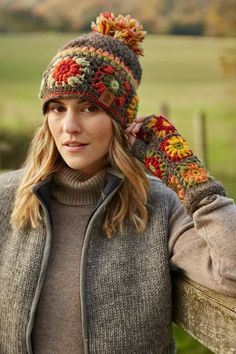 a woman wearing a knitted hat and mittens