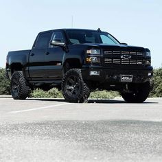 a black truck parked in a parking lot