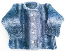 a blue knitted sweater with buttons on the collar and sleeves, sitting on a white surface