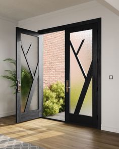 an open glass door in front of a brick wall and potted plant next to it