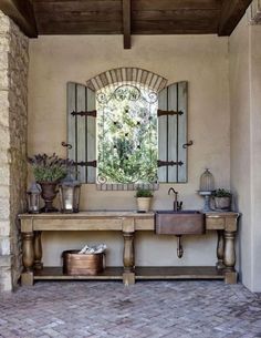 a bathroom with a sink, mirror and potted plants