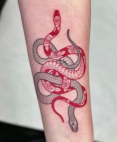 a red and black snake tattoo on the arm