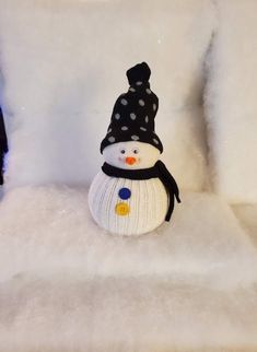 a snowman sitting on top of a white couch