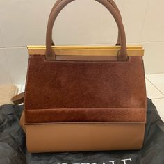 Brand New Camel Color Leather Bag Satchel With Dust Bag For Shopping, Brown Rectangular Satchel With Dust Bag, Brown Satchel Box Bag With Dust Bag, Brown Briefcase With Top Handle And Dust Bag, Shopping Satchel Flap Bag With Handles, Brown Tote Flap Bag For Shopping, Cognac Evening Bag With Top Carry Handle, Chic Cognac Bags With Handles, Cognac Top Handle Bag With Handles