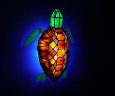 a stained glass turtle lamp in the dark