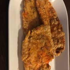 two pieces of fried food on a white plate