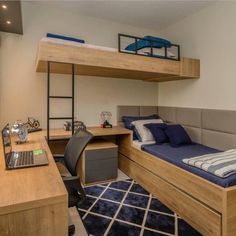 a bedroom with bunk beds, desk and computer