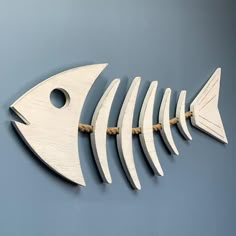 a wooden fish skeleton hanging on the wall