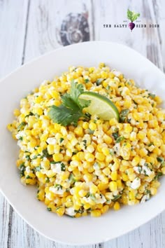 a white bowl filled with corn and cilantro