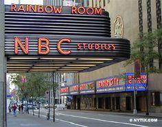 the rainbow room sign is lit up in red, white and blue for nbc studios