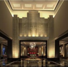 an elegant lobby with chandelier and marble floors in a hotel or apartment building