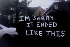 a car parked in front of a sign that says i'm sorry it ended like this