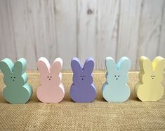 four small wooden bunnies in pastel colors