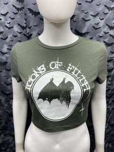 This is an official Icons of Filth cropped forest green screen printed short sleeved top.This has the Icons Image screen printed on the front. 57% Cotton/ 38% polyester/ 5% spandexThese are handmade screenprinted and slightly vary from the photo. Please feel free to email me any questions. Thanks for looking.I do not do exchanges and I do not take returns unless the item is damaged. I thoroughly check each item before it is shipped out. Grunge Cropped T-shirt For Summer, Green Crop Top For Streetwear In Spring, Green Fitted Edgy Tops, Punk Graphic Print Short Sleeve Crop Top, Punk Style Graphic Print Crop Top With Short Sleeves, Spring Punk Crew Neck Crop Top, Punk Style Crew Neck Crop Top For Spring, Edgy Short Sleeve Crop Top With Graphic Print, Spring Punk Style Crew Neck Crop Top