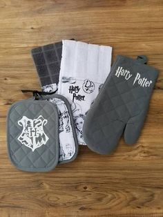 harry potter oven mitts and pot holders on a wooden table with harry potter towels