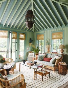 a living room filled with lots of furniture and decor on top of a white rug