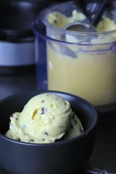 a bowl filled with ice cream next to a blender