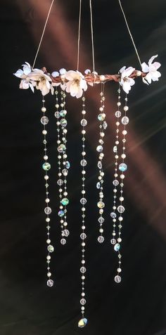 a chandelier with flowers and beads hanging from it