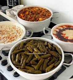 three bowls filled with different types of food on top of a stovetop oven next to rice