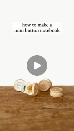 a wooden table topped with lots of different types of buttons and words that read how to make a mini button notebook