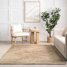 a living room with a couch, chair and potted plant on the table in front of it