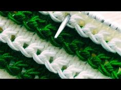 crocheted green and white stitching with scissors