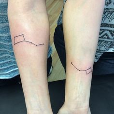 two people with matching tattoos on their legs, one is holding the other's arm