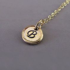 Tiny 14k Yellow Gold Initial Necklace  Pebble by esdesigns on Etsy Minimalist Personalized Charm Necklaces In Recycled Gold, Minimalist Personalized Charm Necklace In Recycled Gold, Everyday Personalized Charm Necklace In Recycled Gold, Personalized Charm Necklace In Recycled Gold For Everyday, Everyday Personalized Recycled Gold Charm Necklace, 14k Gold Hand Stamped Charm Necklaces With Round Pendant, Hand Stamped 14k Gold Round Pendant Charm Necklaces, Hand Stamped 14k Gold Charm Necklace With Round Pendant, Minimalist Personalized Jewelry For Meditation