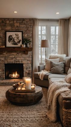 a living room filled with furniture and a fire place in front of a stone fireplace