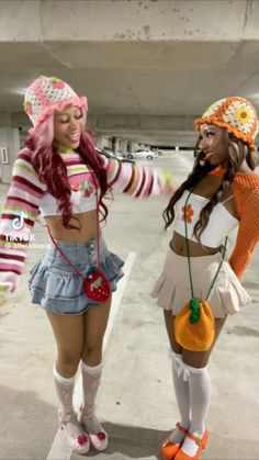 two women dressed in costumes standing next to each other