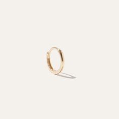 Solo hoops are sleek and chic as can be. Meet our solid 14k gold mini hoop earring. Perfect for second or third piercings, with a hinge clasp for easy wearing. Sold individually. | Women's 14k Solo Mini Hoop Earrings in Yellow Gold | 14k Gold | Quince | Quince | Women's 14k Solo Mini Hoop Earrings in Yellow Gold, 14k Gold Gold Quince, Mini Hoop Earrings, Quince, Yellow Color, Affiliate Links, Piercings, 14k Gold, Hoop Earrings, Stud Earrings