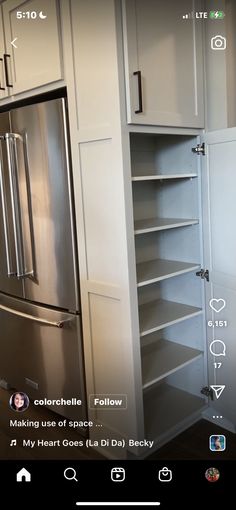 a kitchen with stainless steel appliances and white cupboards, including an appliance